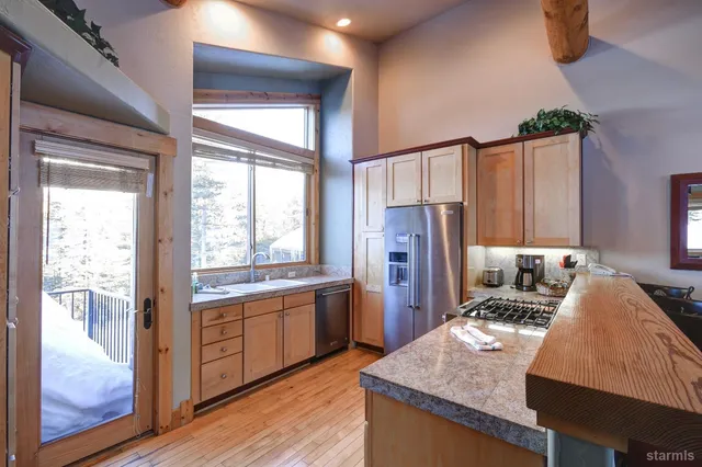 a view of a dining room with furniture a chandelier and wooden floor