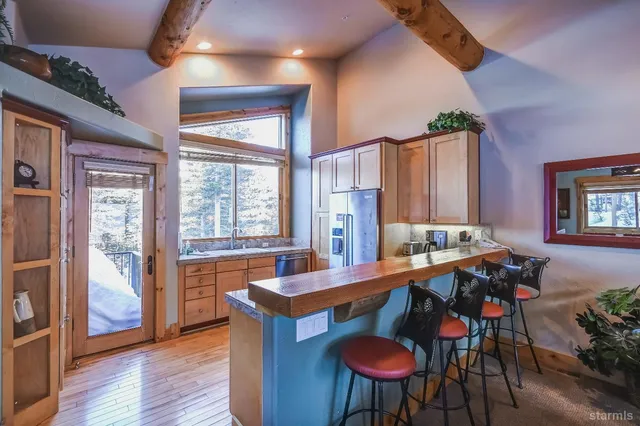 a bathroom with a granite countertop sink and a window