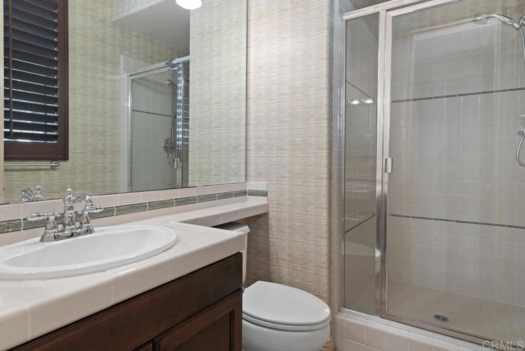 5473 Valerio Trail San Diego, CA 92130 - Photo 16 of 39 a bathroom with a sink toilet and shower
