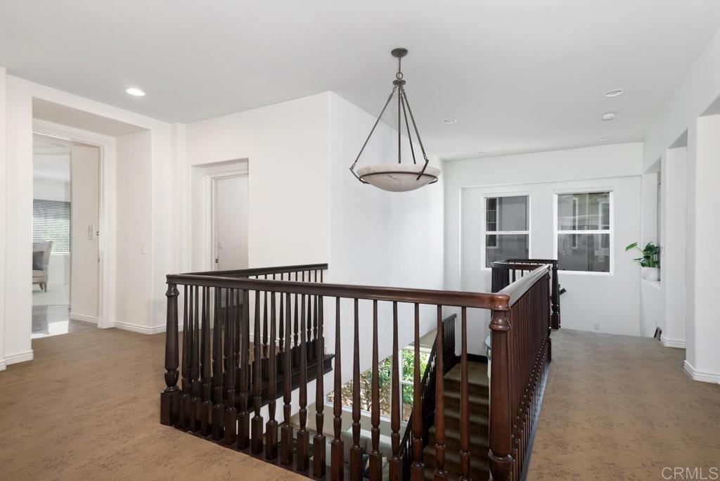 5473 Valerio Trail San Diego, CA 92130 - Photo 17 of 39 a view of a hallway with windows