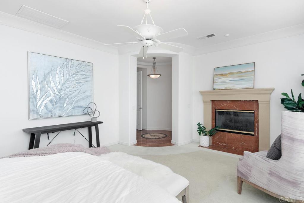 5473 Valerio Trail San Diego, CA 92130 - Photo 21 of 39 a bedroom with a bed and a fireplace