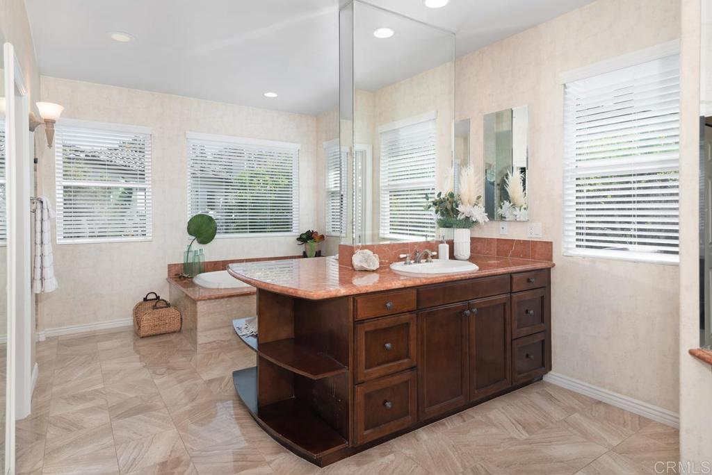 5473 Valerio Trail San Diego, CA 92130 - Photo 22 of 39 a spacious bathroom with a granite countertop sink and a large window