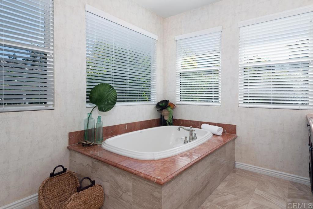 5473 Valerio Trail San Diego, CA 92130 - Photo 24 of 39 a bath tub sitting in a bathroom next to a window