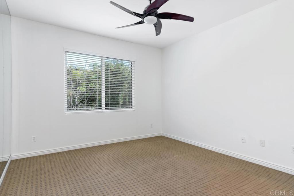 5473 Valerio Trail San Diego, CA 92130 - Photo 28 of 39 an empty room with a window and a ceiling fan
