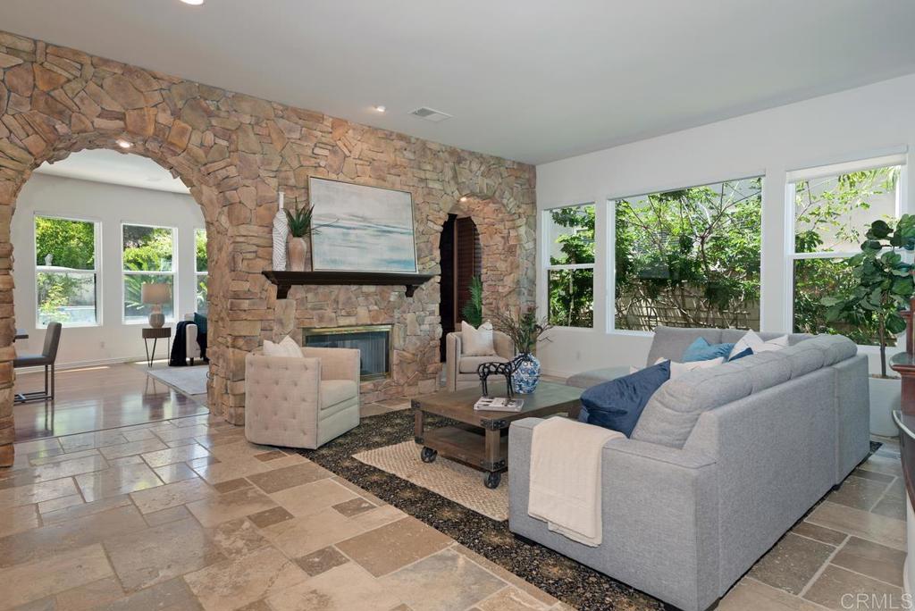 5473 Valerio Trail San Diego, CA 92130 - Photo 3 of 39 a living room with fireplace furniture and a large window