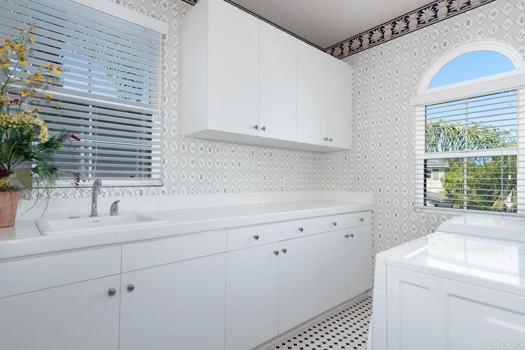 5473 Valerio Trail San Diego, CA 92130 - Photo 32 of 39 a kitchen with a sink and cabinets