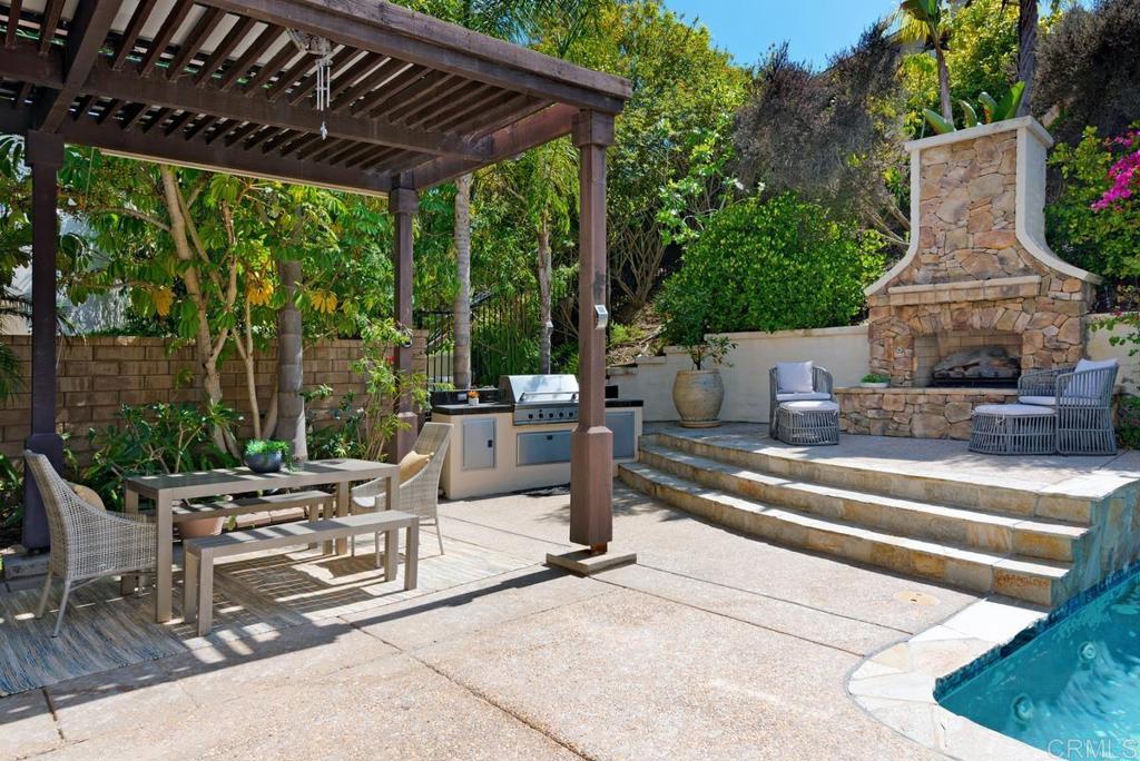 5473 Valerio Trail San Diego, CA 92130 - Photo 35 of 39 a view of patio with table and chairs potted plants and large tree