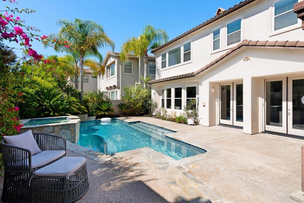 5473 Valerio Trail San Diego, CA 92130 - Photo 37 of 39 a view of a house with backyard sitting area and garden