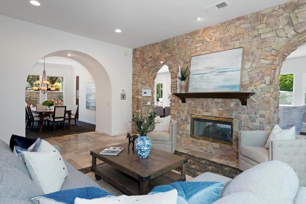 5473 Valerio Trail San Diego, CA 92130 - Photo 4 of 39 a living room with furniture and a fireplace