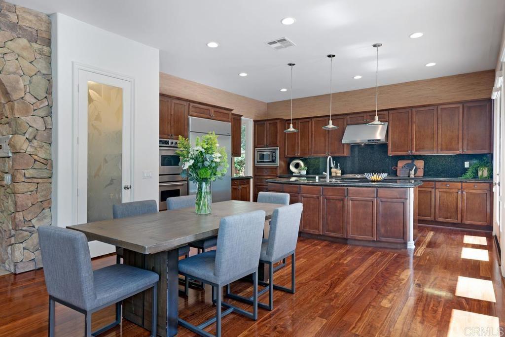 5473 Valerio Trail San Diego, CA 92130 - Photo 10 of 39 a kitchen with a table and chairs in it