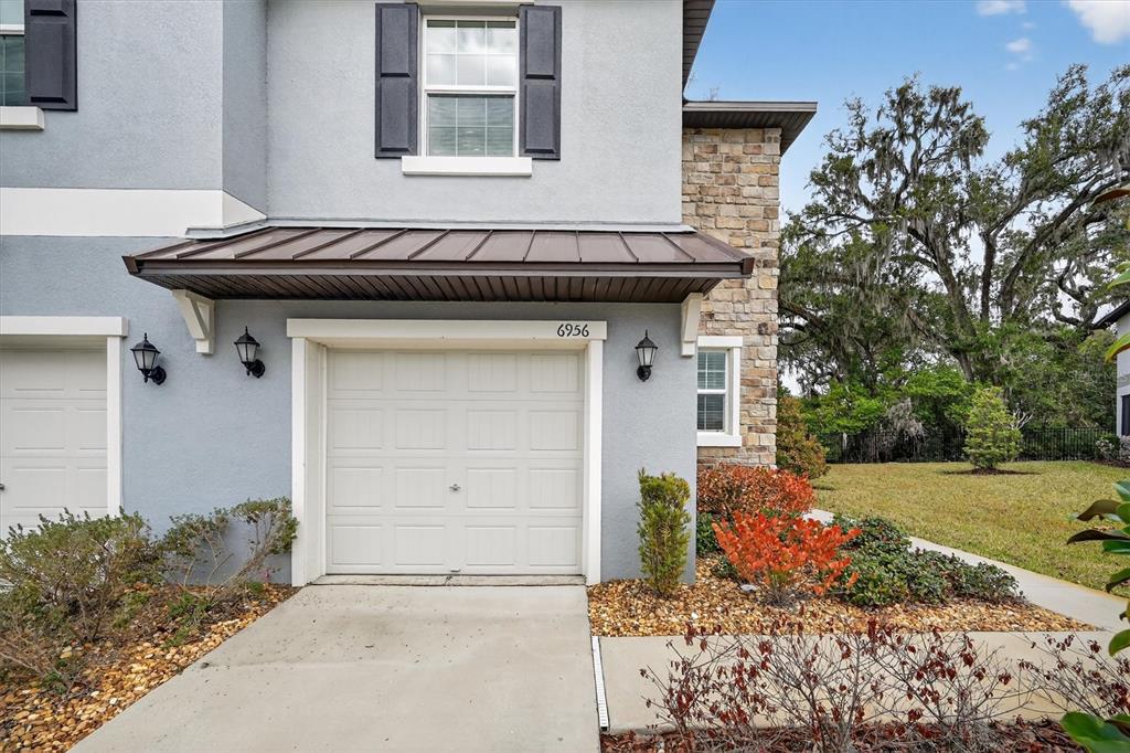 6956 Ripple Pond Loop Zephyrhills, FL 33541 - Photo 1 of 30 a front view of a house with a yard