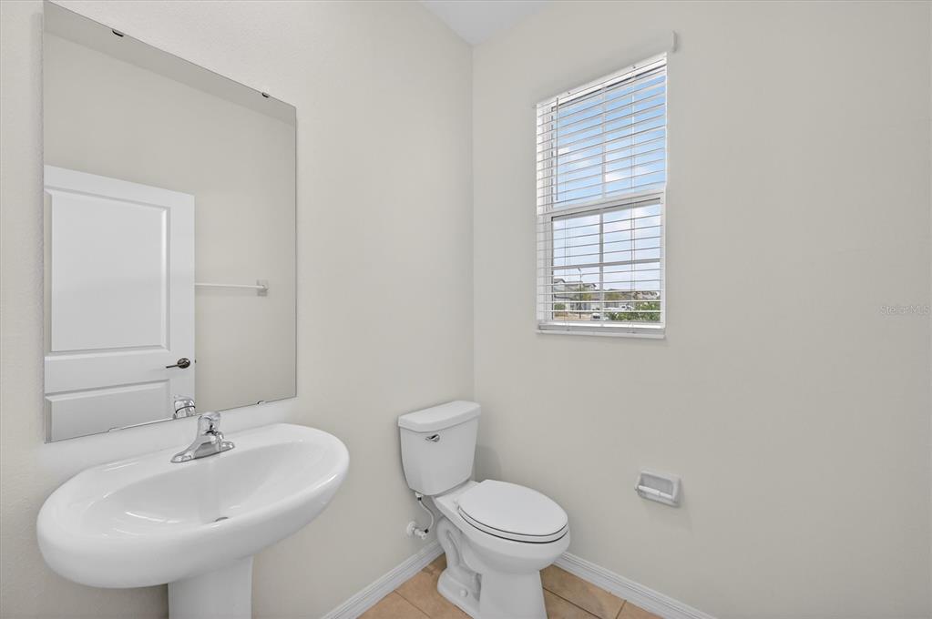 6956 Ripple Pond Loop Zephyrhills, FL 33541 - Photo 13 of 30 a bathroom with a sink toilet and a mirror