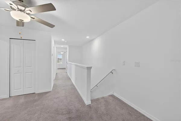 a view of a hallway with staircase