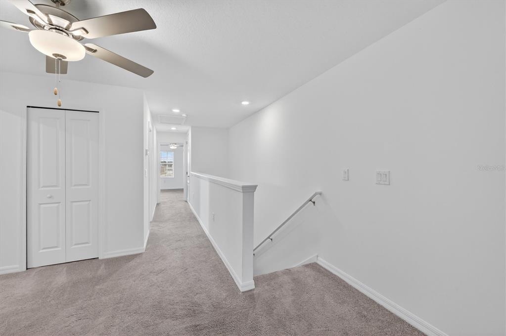 6956 Ripple Pond Loop Zephyrhills, FL 33541 - Photo 14 of 30 a view of a hallway with staircase
