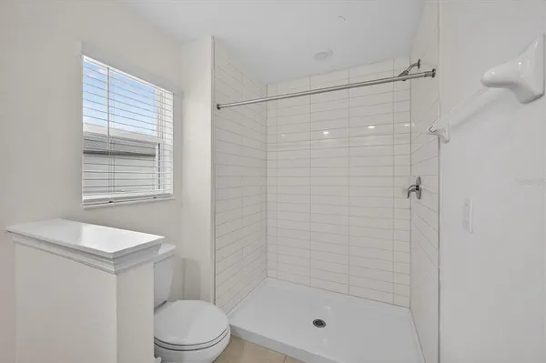 a bathroom with a shower a toilet and sink