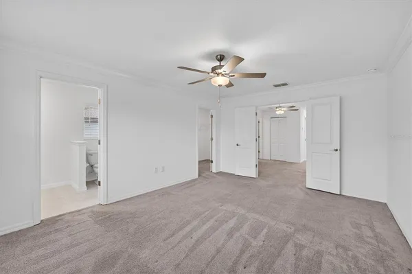 a view of an empty room with a ceiling fan