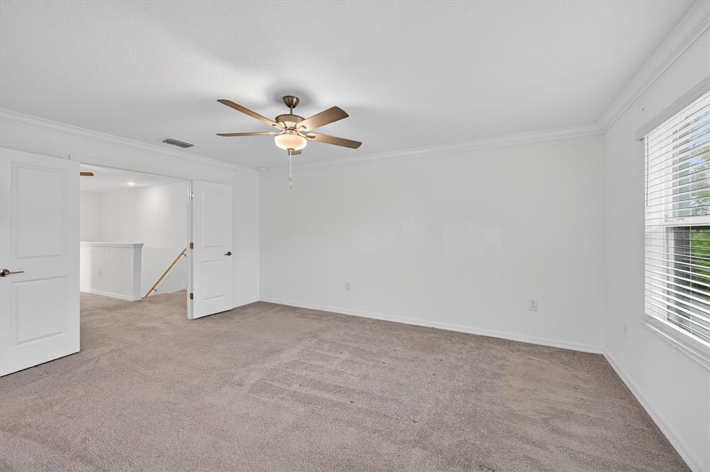 6956 Ripple Pond Loop Zephyrhills, FL 33541 - Photo 19 of 30 an empty room with a window and a fan