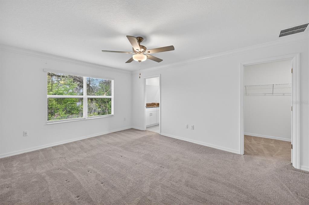 6956 Ripple Pond Loop Zephyrhills, FL 33541 - Photo 21 of 30 an empty room with a window and a fan