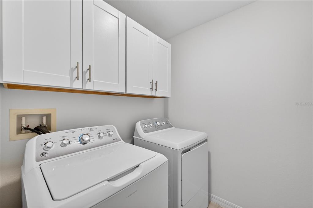 6956 Ripple Pond Loop Zephyrhills, FL 33541 - Photo 23 of 30 a utility room with dryer and washer