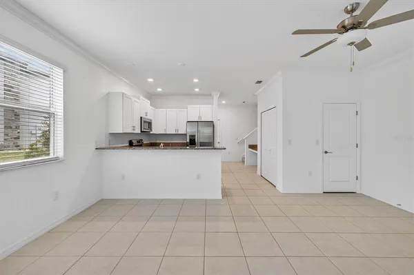 a view of kitchen with white cabinets