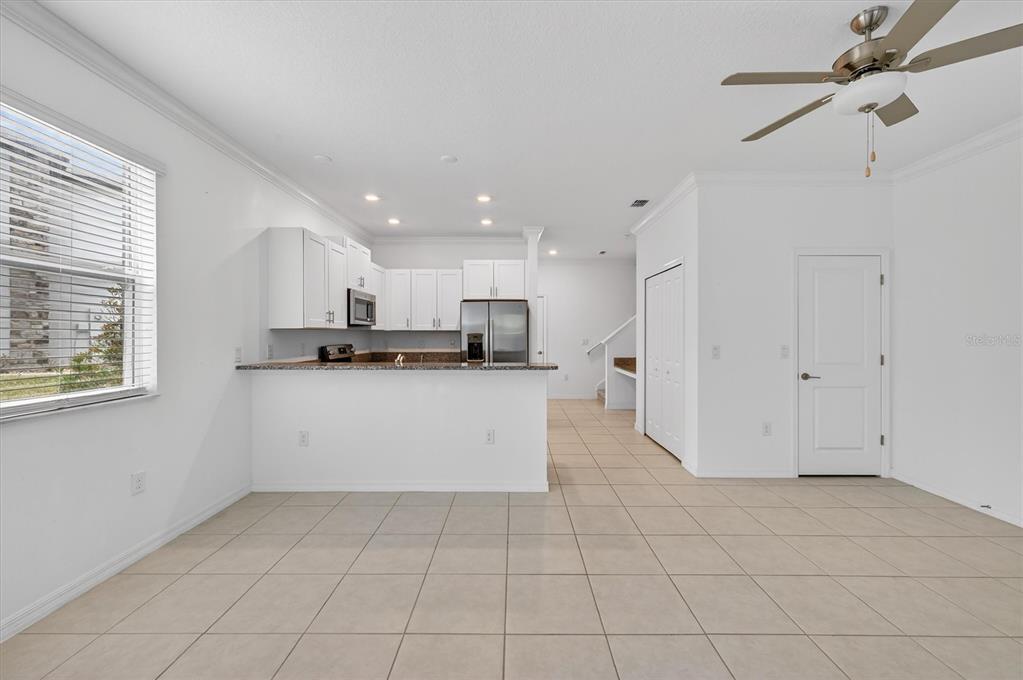 6956 Ripple Pond Loop Zephyrhills, FL 33541 - Photo 8 of 30 a view of kitchen with white cabinets