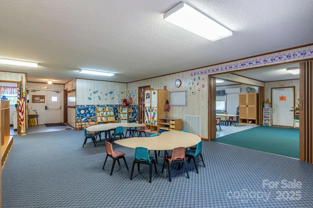 a view of a dining area with furniture and white kitchen