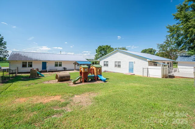 a view of a workspace with furniture and a flat screen tv