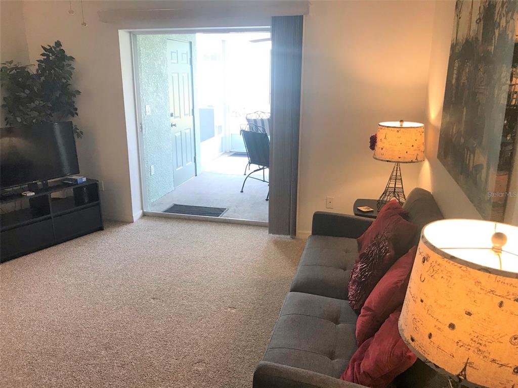26386 Nadir Road, Unit 401 Punta Gorda, FL 33983 - Photo 13 of 42 a living room with furniture and a flat screen tv