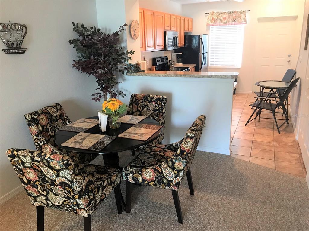 26386 Nadir Road, Unit 401 Punta Gorda, FL 33983 - Photo 19 of 42 a view of a dining room with furniture window and outside view