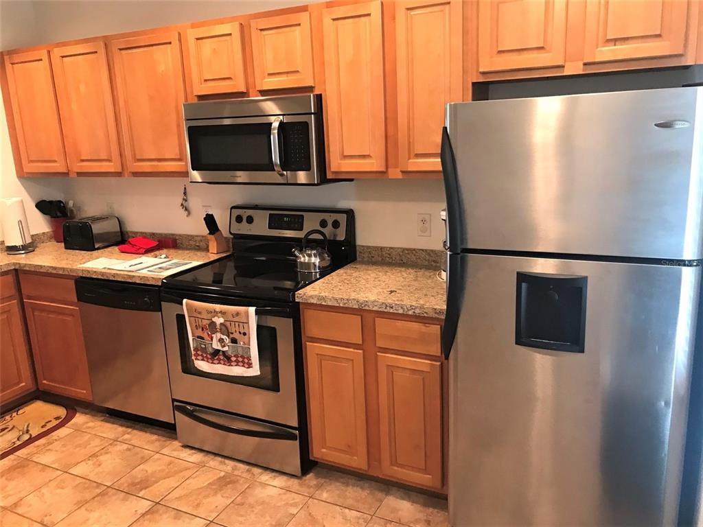 26386 Nadir Road, Unit 401 Punta Gorda, FL 33983 - Photo 2 of 42 a kitchen with a refrigerator and a stove top oven
