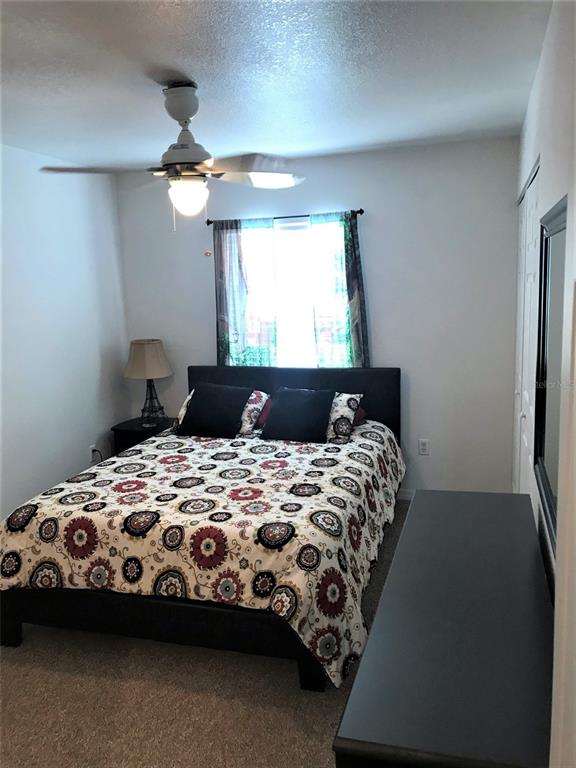 26386 Nadir Road, Unit 401 Punta Gorda, FL 33983 - Photo 22 of 42 a bedroom with a bed and a window