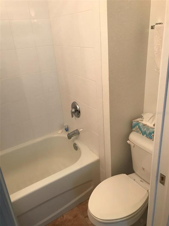 26386 Nadir Road, Unit 401 Punta Gorda, FL 33983 - Photo 25 of 42 a white toilet and tub sitting next to a bathroom sink