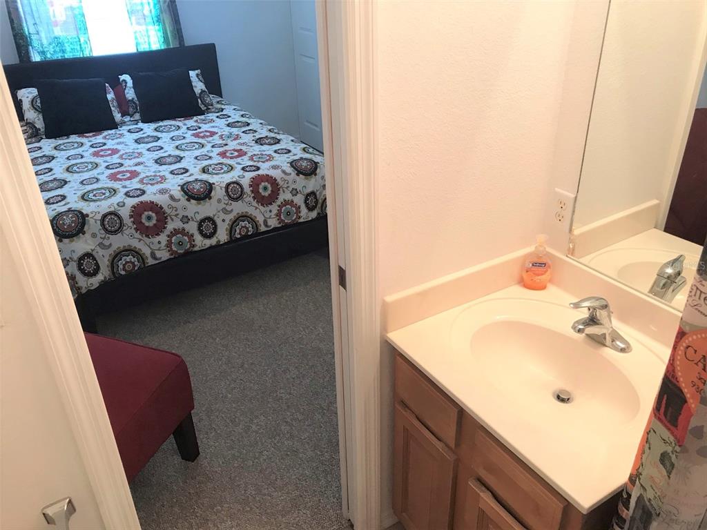 26386 Nadir Road, Unit 401 Punta Gorda, FL 33983 - Photo 27 of 42 a bedroom with a bed and a sink