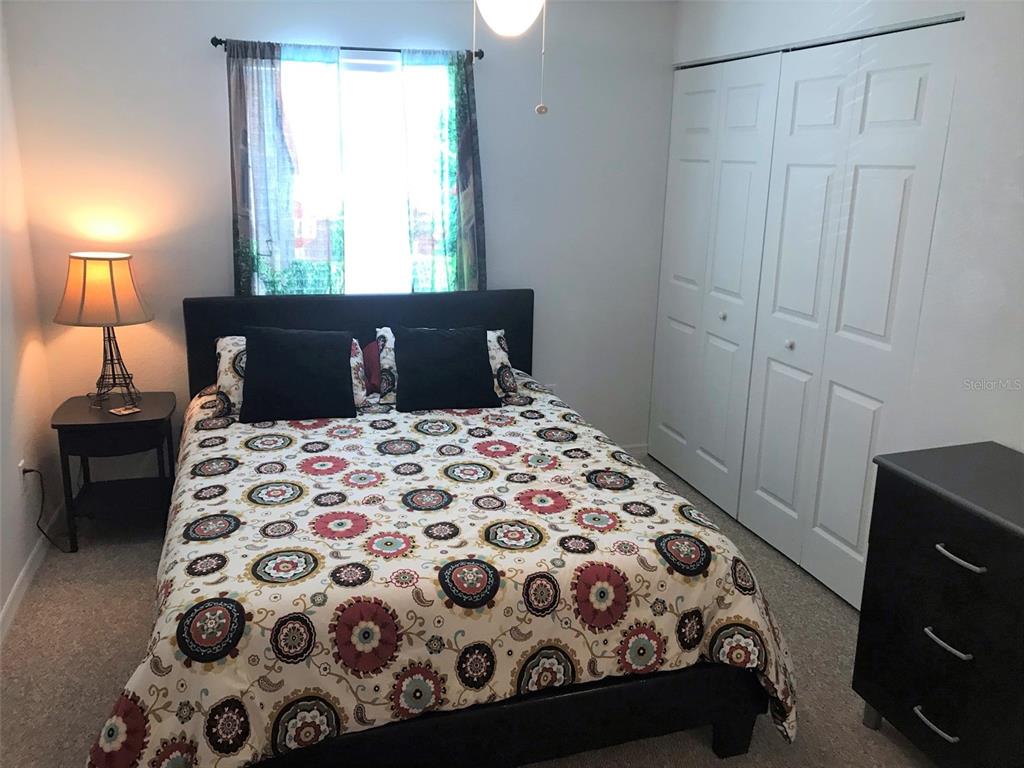 26386 Nadir Road, Unit 401 Punta Gorda, FL 33983 - Photo 28 of 42 a bedroom with a large bed and a lamp