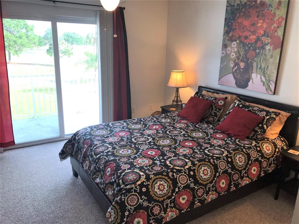 26386 Nadir Road, Unit 401 Punta Gorda, FL 33983 - Photo 30 of 42 a bedroom with a bed and a painting on the wall