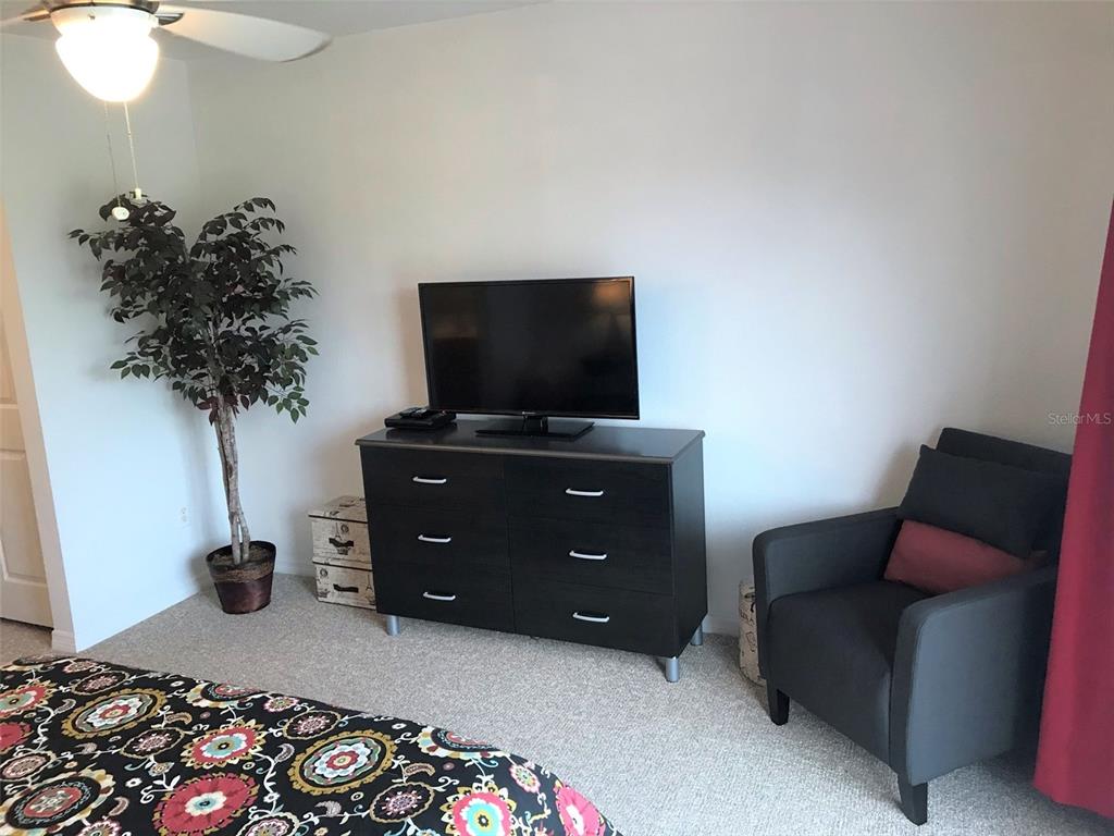 26386 Nadir Road, Unit 401 Punta Gorda, FL 33983 - Photo 32 of 42 a livingroom with a window and a chair
