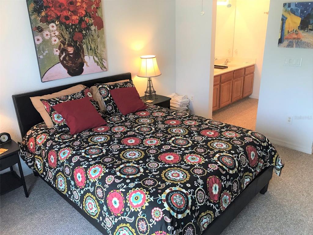 26386 Nadir Road, Unit 401 Punta Gorda, FL 33983 - Photo 33 of 42 a bed sitting in a bedroom next to a window