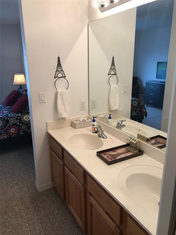 26386 Nadir Road, Unit 401 Punta Gorda, FL 33983 - Photo 39 of 42 a bathroom with a double vanity sink and a mirror