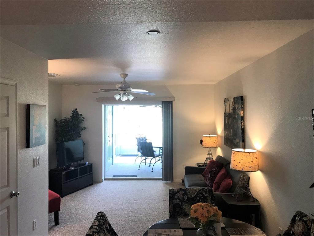 26386 Nadir Road, Unit 401 Punta Gorda, FL 33983 - Photo 7 of 42 a living room with furniture and a window