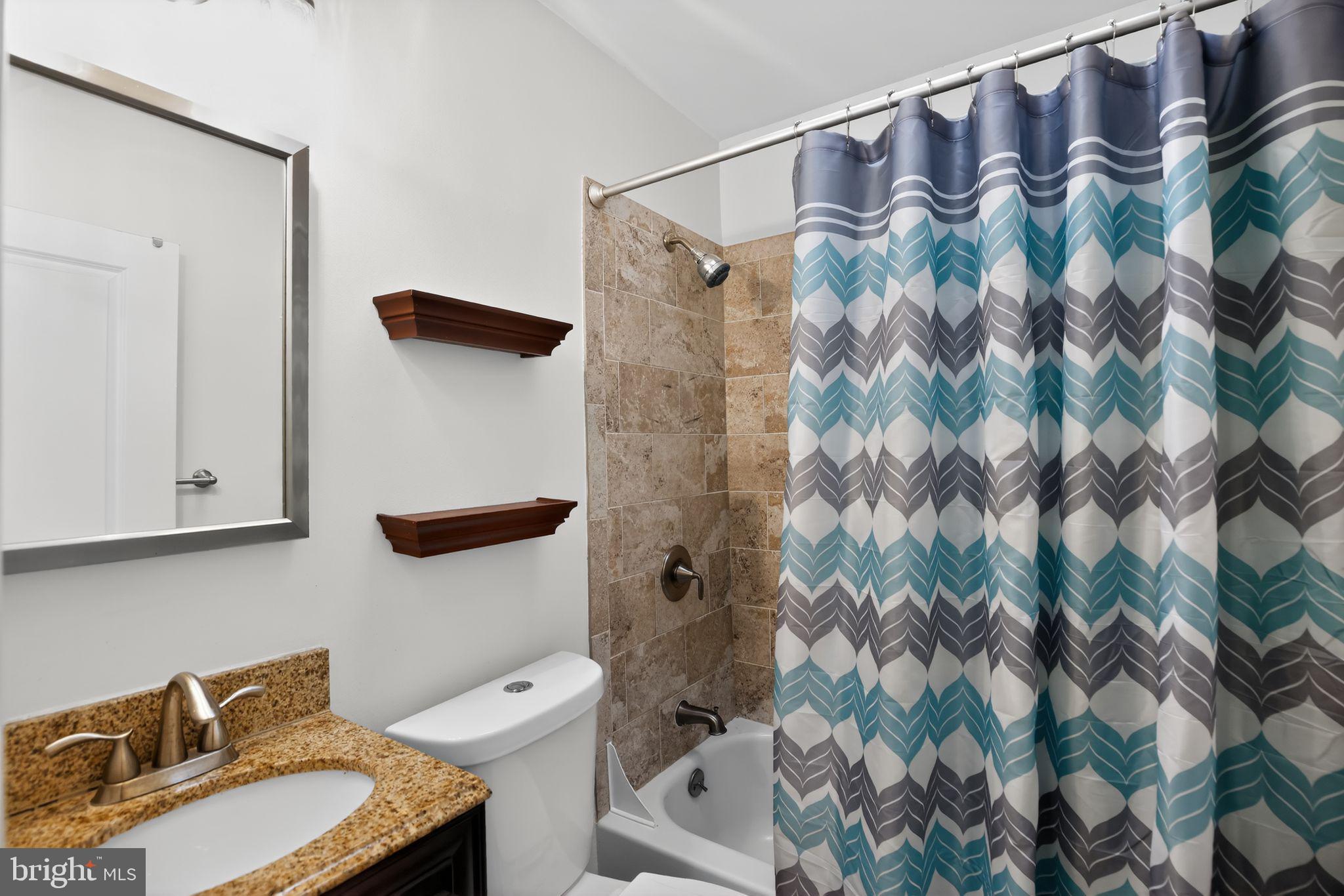 6843 Dunbar Road Baltimore, MD 21222 - Photo 12 of 27 a bathroom with a sink toilet and shower