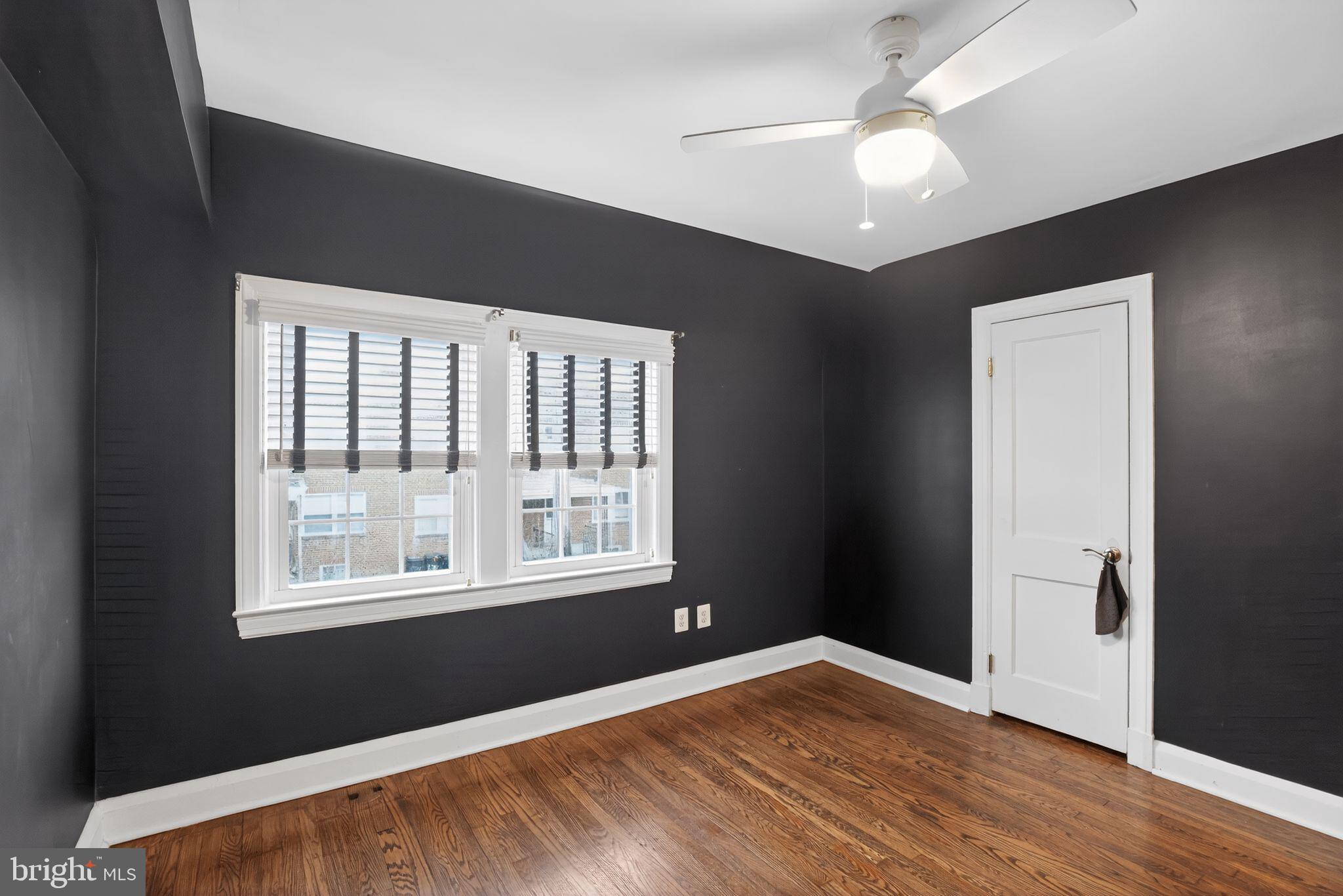 6843 Dunbar Road Baltimore, MD 21222 - Photo 13 of 27 a view of an empty room with wooden floor and a window