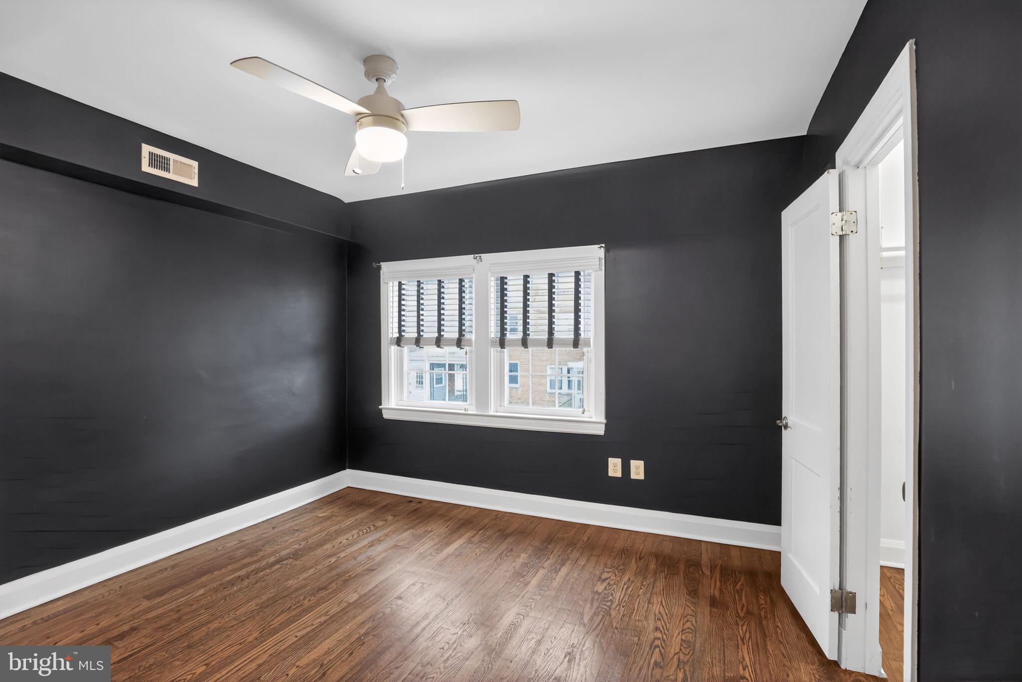 6843 Dunbar Road Baltimore, MD 21222 - Photo 15 of 27 a view of an empty room with wooden floor and a window