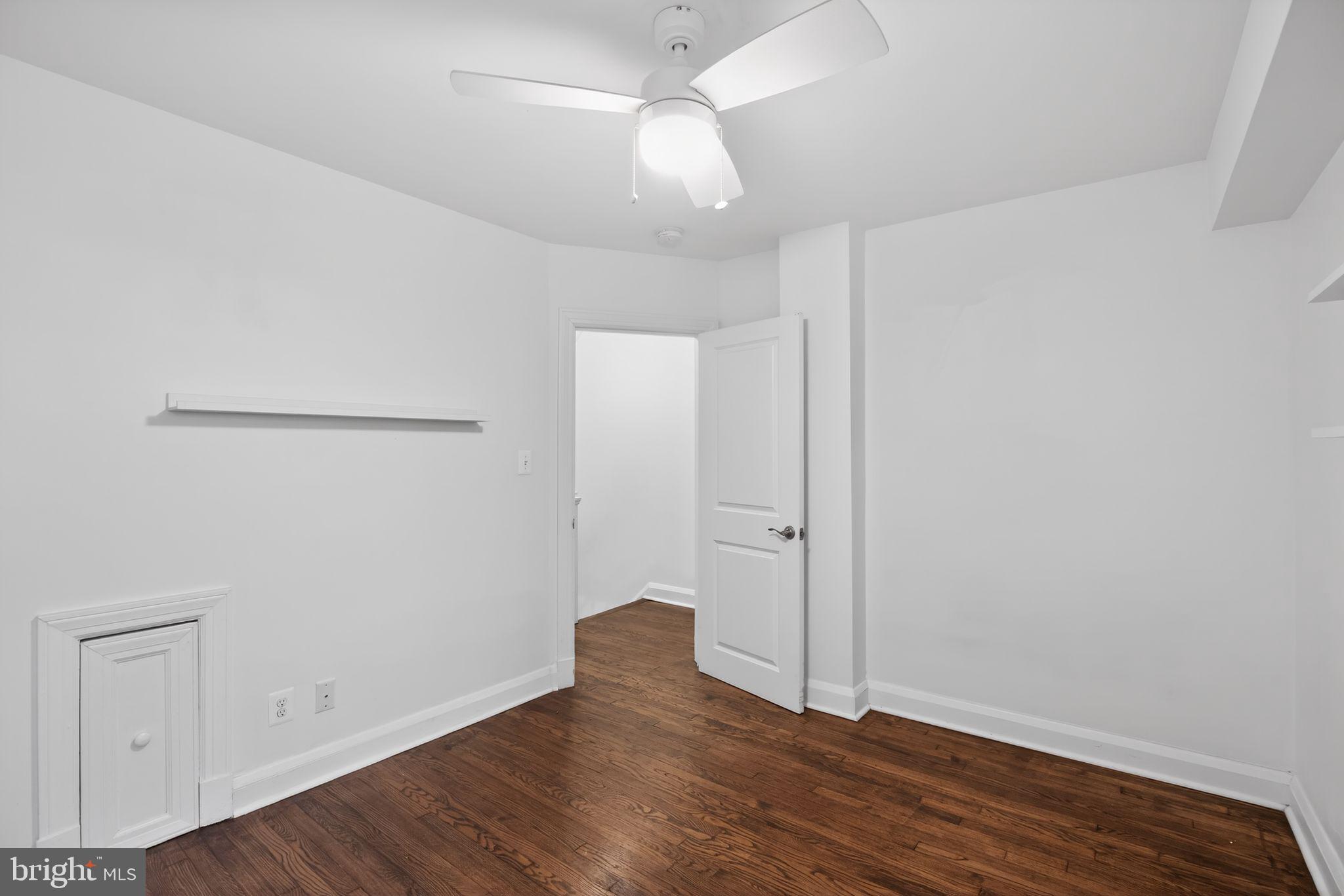6843 Dunbar Road Baltimore, MD 21222 - Photo 19 of 27 an empty room with wooden floor