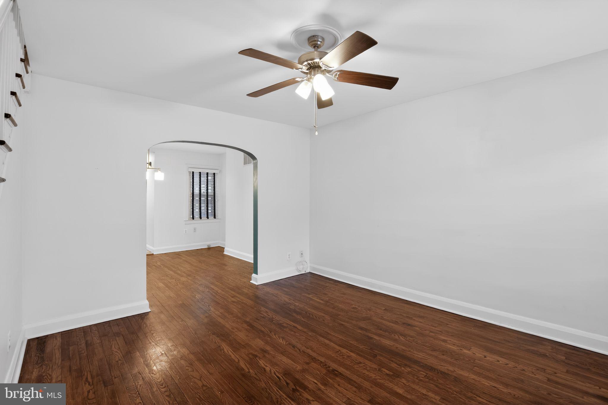 6843 Dunbar Road Baltimore, MD 21222 - Photo 5 of 27 wooden floor in an empty room with a window