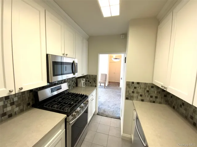 a kitchen with a sink and a stove top oven