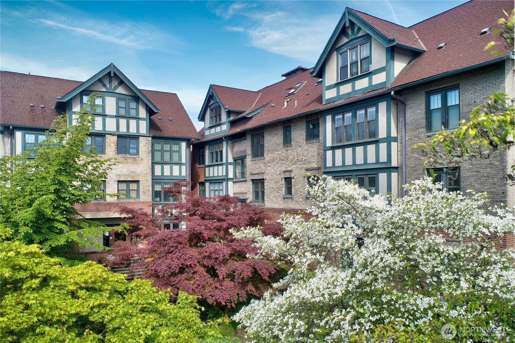 409 16th Avenue East, Unit 21 Seattle, WA 98112 - Photo 1 of 25 a front view of a house with garden
