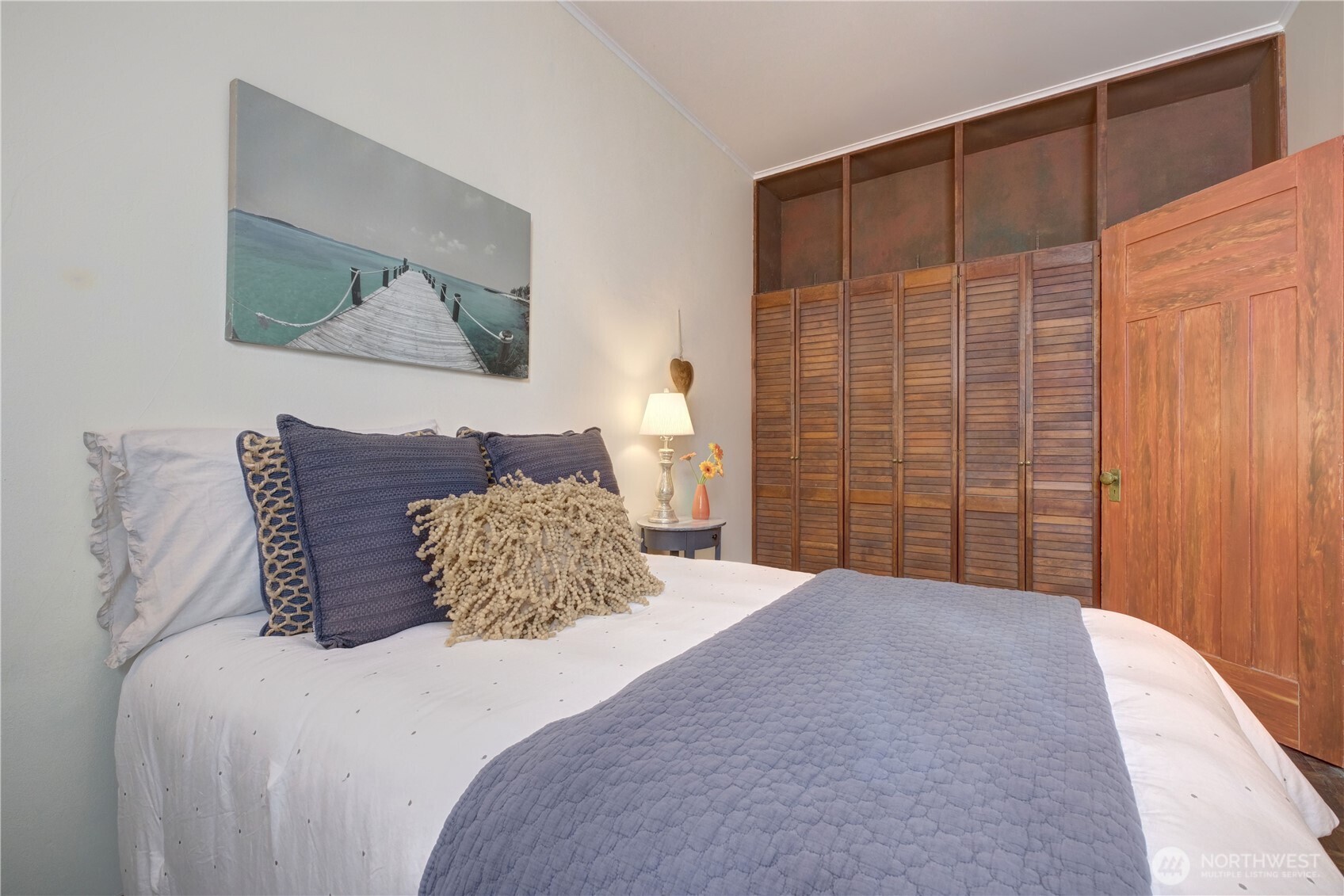 409 16th Avenue East, Unit 21 Seattle, WA 98112 - Photo 17 of 25 a bedroom with a large bed and a painting on the wall