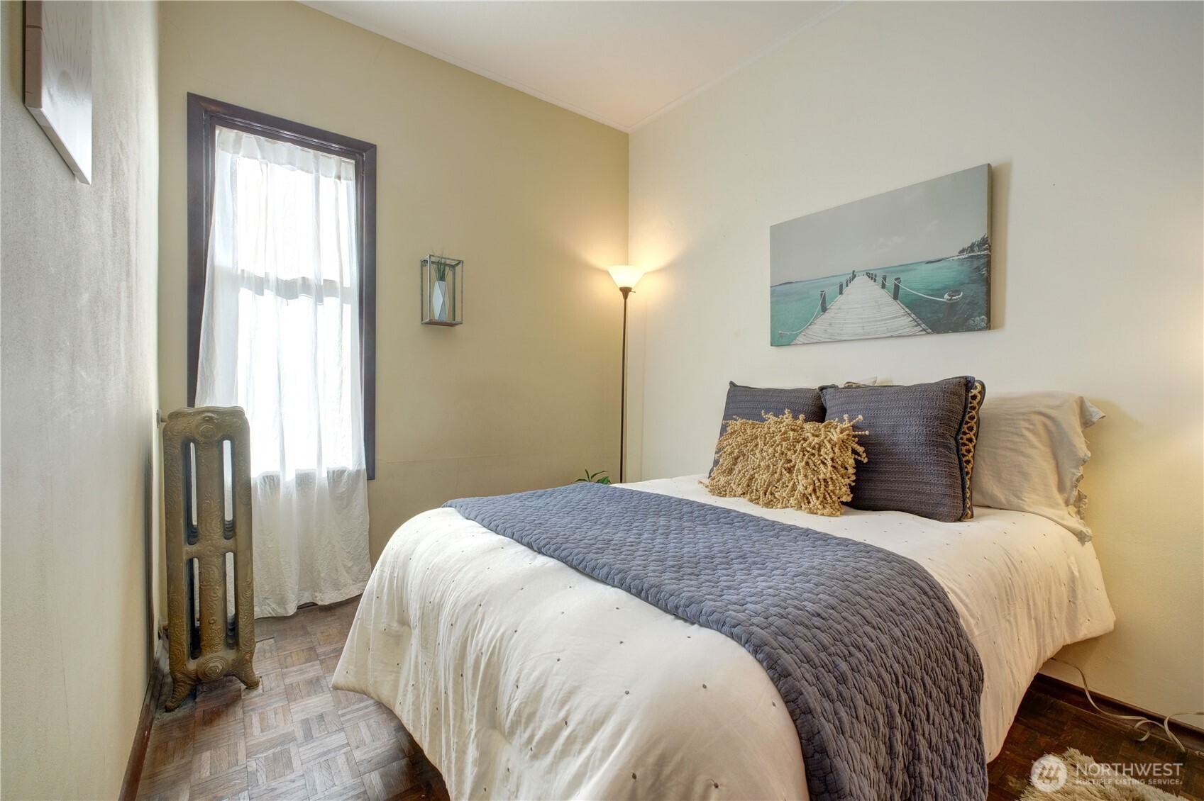 409 16th Avenue East, Unit 21 Seattle, WA 98112 - Photo 18 of 25 a bedroom with a bed and a painting on the wall