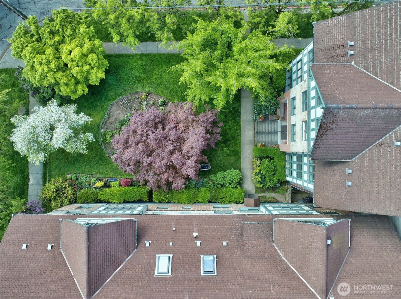 409 16th Avenue East, Unit 21 Seattle, WA 98112 - Photo 2 of 25 an aerial view of a house with a yard and garden