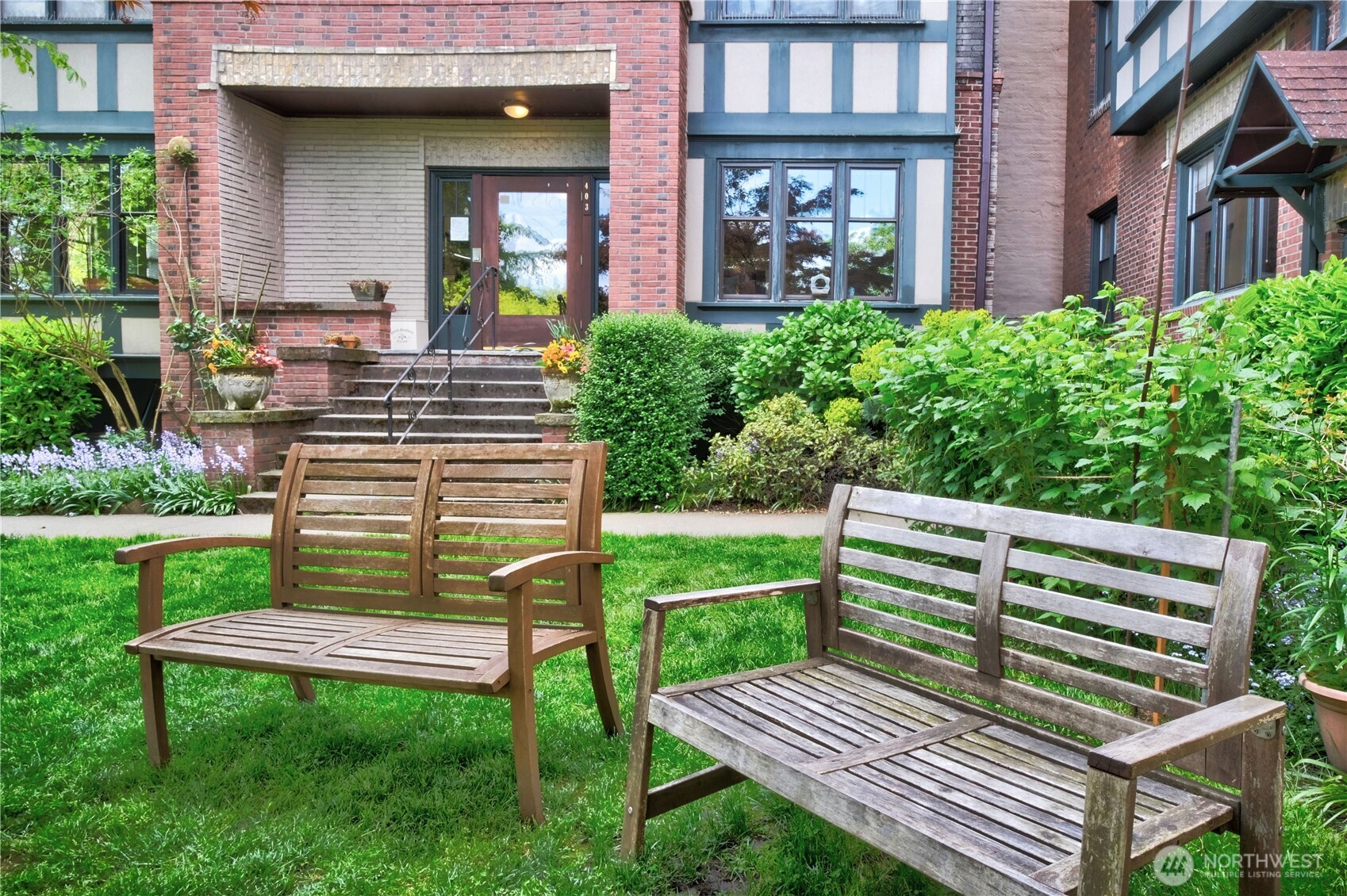 409 16th Avenue East, Unit 21 Seattle, WA 98112 - Photo 3 of 25 a view of a wooden bench in front of house